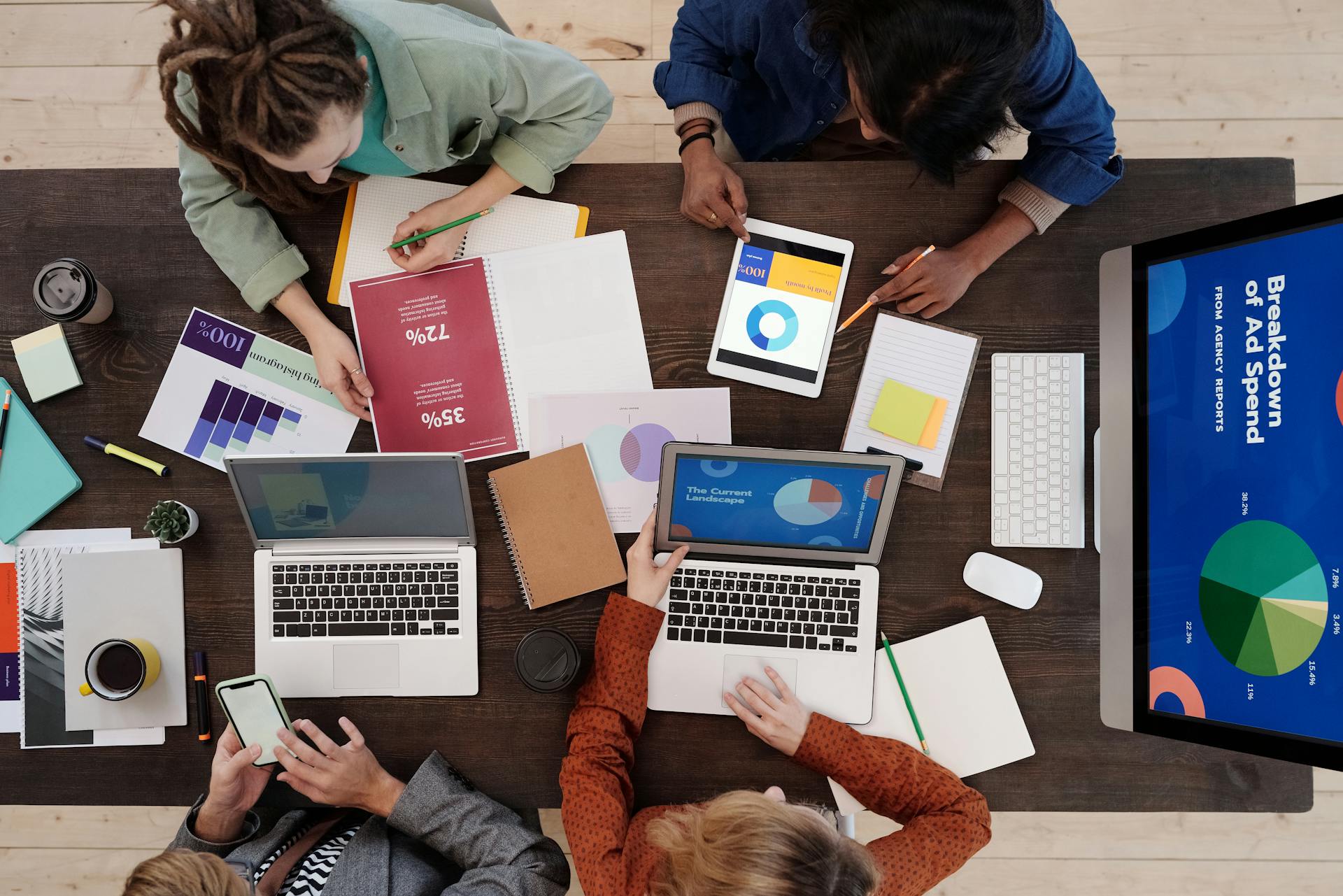 Diverse group reviewing financial charts together