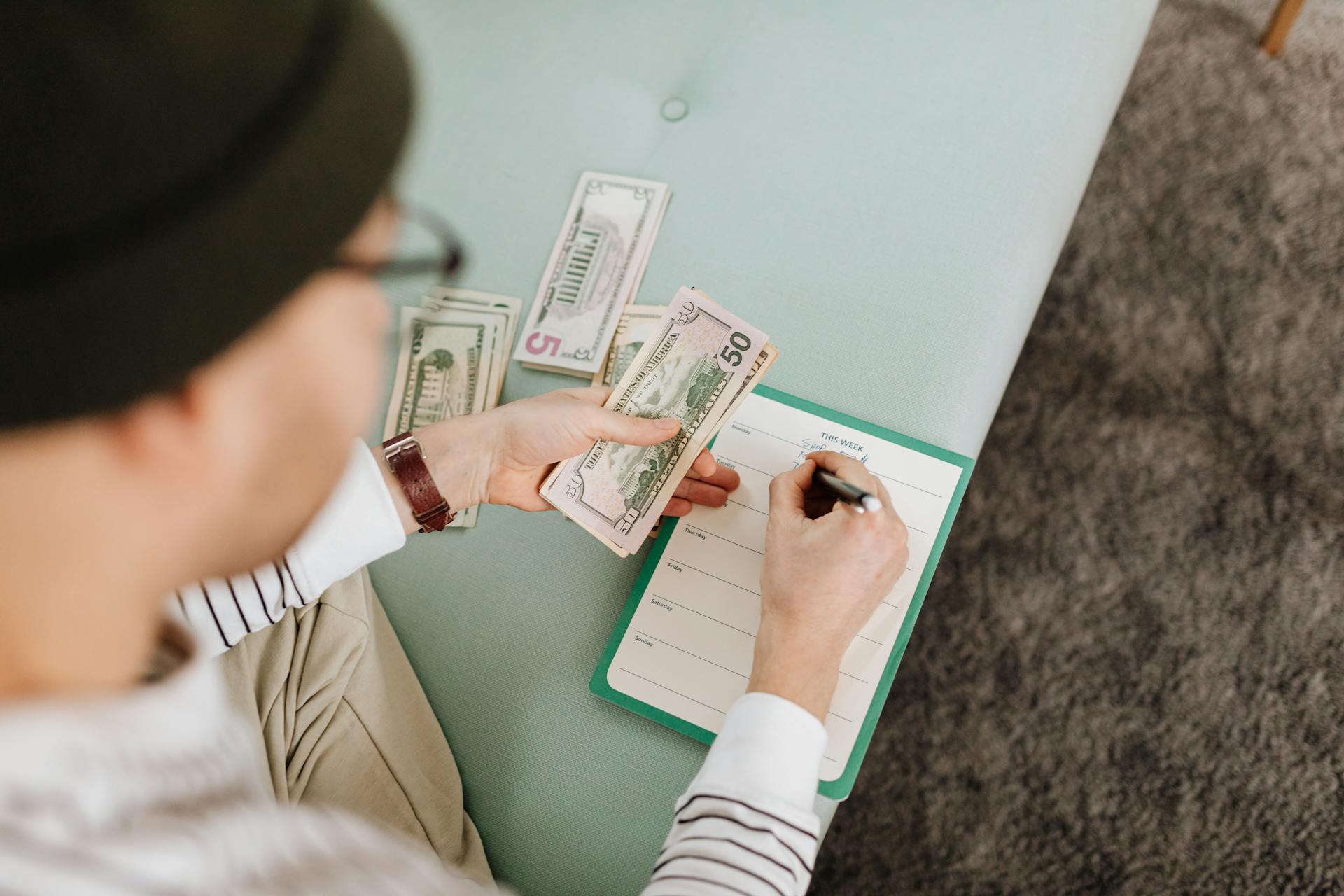 Person planning a budget and counting money